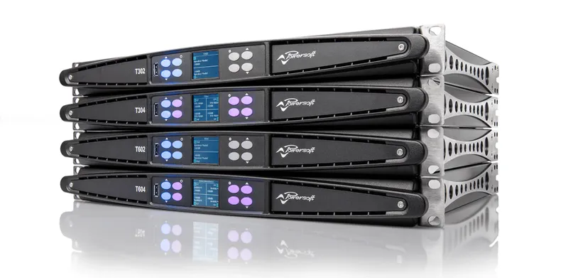 Four T Series amplifiers stacked, front panels with lit channel buttons