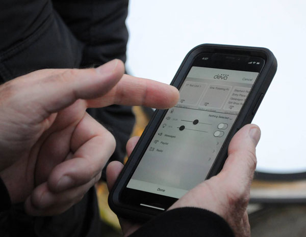 Hands using the Deva app on a smartphone