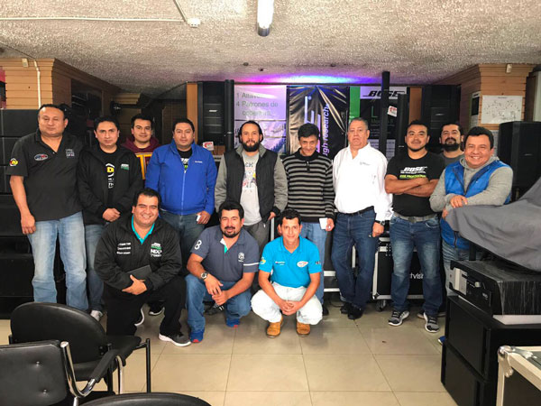 Vallparr training group posing in a showroom with loudspeakers