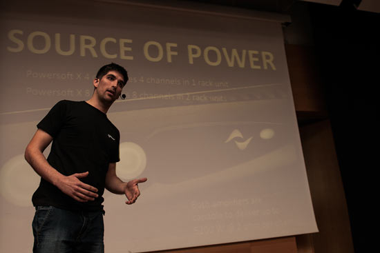Presenter in front of a slide titled Source of Power: X4 with 4 channels in 1 RU, X8 with 8 channels in 2 RU