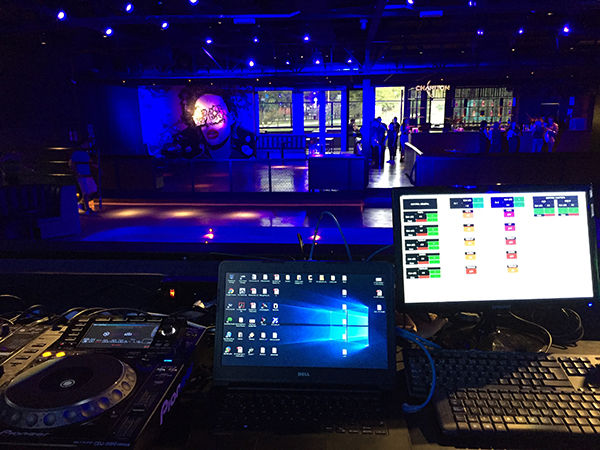 Banana nightclub DJ booth: CD player, laptop and a control screen, with the blue-lit dance floor
