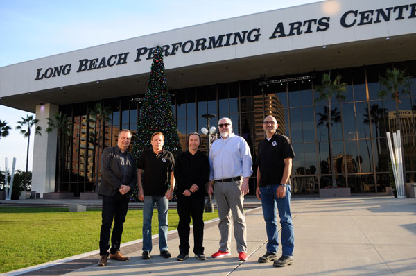 Five men in front of the Long Beach Performing Arts Center, next to a Christmas tree