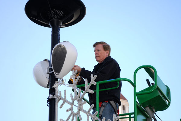 Technician on an aerial lift installing a Deva unit on a lamp post