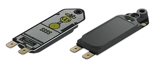 SpeakerMATE module seen from both sides: circuit board and enclosed back, each with two spade terminals